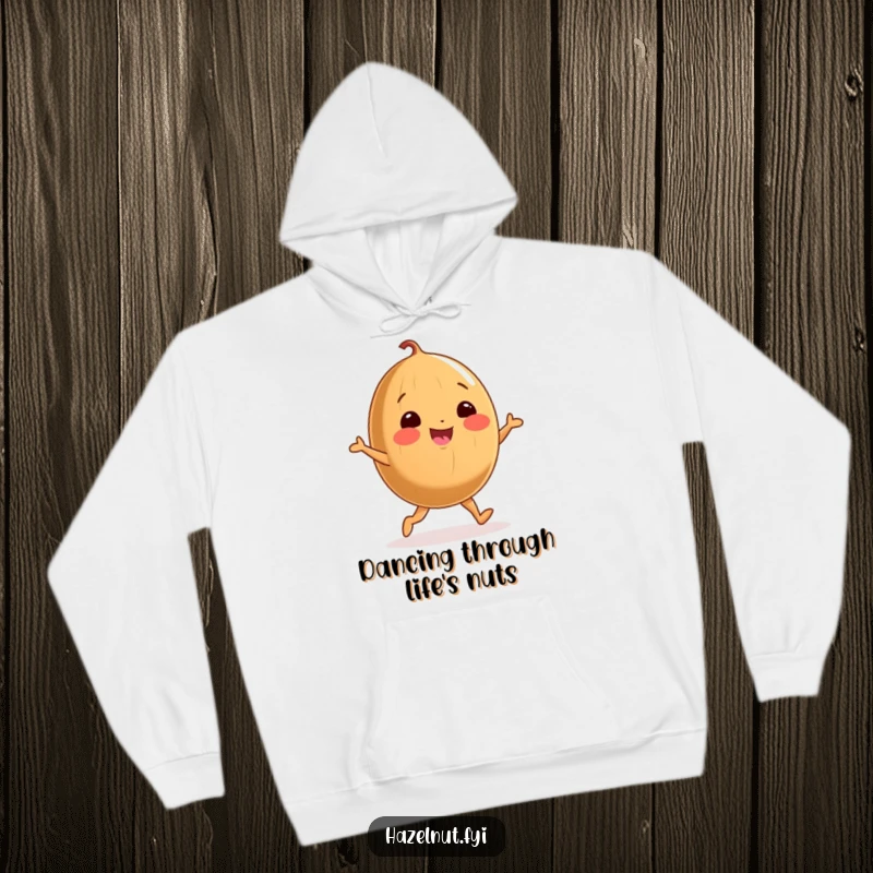 Funny hoodie with a cheerful, round hazelnut on stubby legs doing a joyful dance, radiating warmth and happiness.