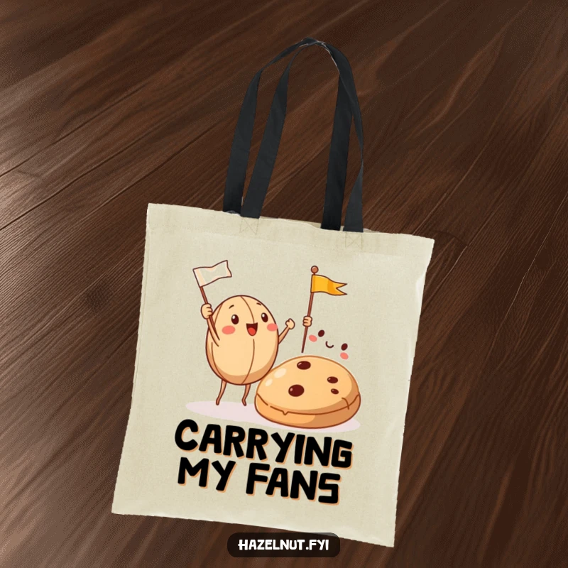 Funny Hazelnut Tote Bag shows hazelnuts cheering with flags towards a cookie, perfect for grocery runs and snack hauling.